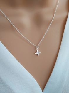 North star necklace sterling silver, Polaris starburst necklace, celestial star jewelry, silver cz diamond star necklace Shine bright with our gorgeous North Star necklace!  Handcrafted with care using a tiny sterling silver & cubic zirconia North Star charm and delicate sterling silver chain, this dainty necklace symbolises hope and inspiration.  The North Star is the anchor of the northern sky, giving guidance and direction to those who follow it. Stunning little cubic zirconia crystals mimic Sterling Silver Star-shaped Jewelry, Silver Star Charm Necklace For Anniversary, Silver Star Charm Necklaces For Anniversary, Elegant Sterling Silver Star Charm Jewelry, Silver Celestial Jewelry For Her, Silver Celestial Jewelry As A Gift For Her, Dazzling Star-shaped Necklace For Anniversary, Dazzling Star-shaped Anniversary Necklace, Dazzling Star-shaped White Gold Necklace