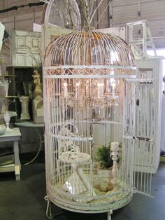 a white birdcage sitting on top of a table