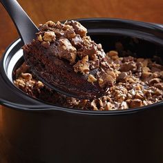 there is a spoon full of chocolate cake in the bowl with words above it that read, peanut butter chocolate pudding cake