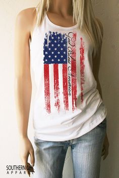 "God Bless America American Flag Red White and Blue Tank Top -Light Weight Cotton Poly -60% Combed Ring-Spun Cotton 40% Polyester -30 single for extreme softness -Pre-shrunk for reduced shrinkage -Finished edge Measurements are taken lying flat Available in Small thru XL SMALL: Length- 28\" - Chest Width- 16\" across seam to seam MEDIUM: Length- 28 1/2\" - Chest Width- 17\" across seam to seam LARGE: Length- 29\" - Chest Width- 18\" across seam to seam XLARGE: Length- 29 1/2\" - Chest Width- 19\ American Flag Clothes, American Flag Tank Top, Gray Shirt, Southern Girl, American Flag Shirt, Gray Tank, Flag Shirt, Blue Tank Top, God Bless America