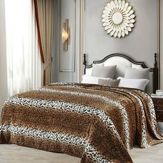 a leopard print bed spread in a bedroom