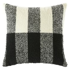 a black and white pillow on a white background