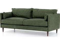 a green couch sitting on top of a white floor