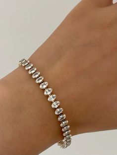 A sparkling tennis bracelet that is waterproof and tarnish free. What else you could ask for. Made of 38 oval AAA cubic zircon, the bracelet is eye-catching and flexible. Tennis Bracelet, Tennis, Charm Bracelet, Gemstones