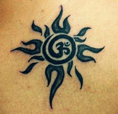 a tattoo on the back of a woman's shoulder with an omen symbol