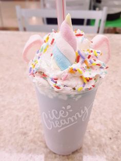 an ice cream sundae with unicorn ears and sprinkles