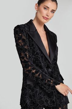 DESCRIPTION & FEATURES Discover a modern twist on classic tailoring with our VALIA blazer, crafted from sheer black velvet embroidered lace, revealing just a hint of skin. This blazer features a contrast satin lapel, internal shoulder pads, and elegant scallop detailing to the hem and sleeves. Finished with satin buttons to the sleeve cuff and non-functional pockets to the front. Fully lined for a smooth fit. Pair with our VALIA Black Pants to complete the look. - Signature structured blazer sha Elegant Velvet Blazer For Night Out, Tailored Elegant Blazer For Gala, Elegant Tailored Blazer For Gala, Formal Fitted Lace Blazer, Luxury Black Velvet Blazer, Luxury Velvet Blazer For Parties, Black Velvet Party Blazer, Elegant Fitted Velvet Blazer, Luxury Velvet Party Blazer