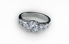 a three stone diamond ring on a white background with the words belfajo written in cursive font