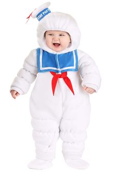 a baby dressed up in a white costume