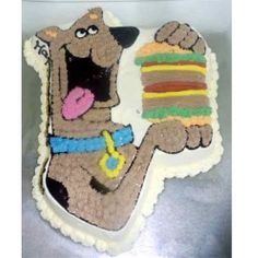 a cake that looks like a dog holding a large piece of cake in it's paws