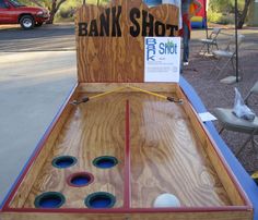 an old fashioned wooden game that is on display at a street vendor's booth