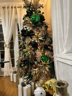 a christmas tree decorated with green and gold ornaments