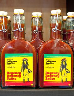 several bottles of raspberry sauce sitting on a shelf with labels in front of them