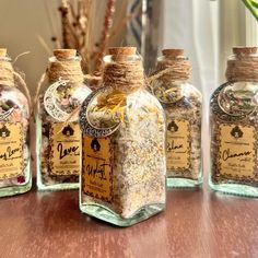 several glass bottles filled with different types of spices