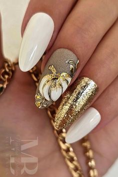 White almond nails with gold glitter accent nail and white and gold pumpkin nail art on another accent nail! Nails With Gold Glitter Accent, Almond Nails With Gold, Nails With Gold Glitter, Pumpkin Nail Designs, Pumpkin Nail, White Almond Nails, Pumpkin Nail Art, Nails With Gold, Gold Pumpkin