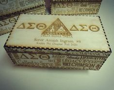 three wooden boxes sitting on top of a white table covered in words and symbols,