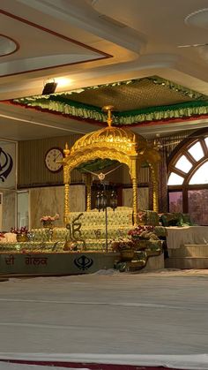 an elaborately decorated stage in the middle of a room with two clocks on each side