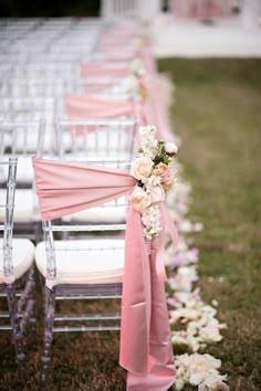 rows of chairs with pink sashes and flowers on them