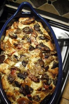 a blue casserole dish sitting on top of a stove