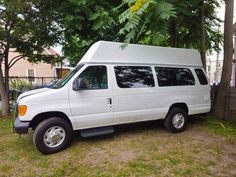 a white van is parked in the grass