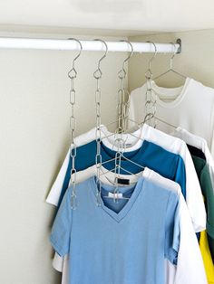 several shirts hanging on a clothes rack in a closet