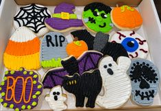 decorated halloween cookies in a box on a table