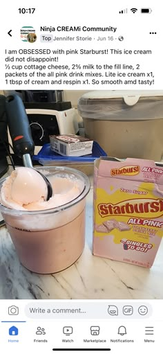 an ice cream sundae is on the table next to a bag of strawberries