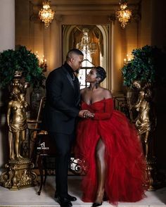 a man and woman in formal wear standing next to each other