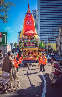 a float is being carried down the street by people