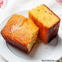 two pieces of cake sitting on top of a white plate next to another piece of bread