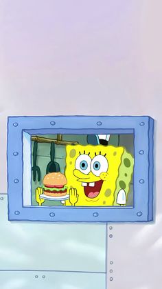 the spongebob character is eating a hamburger in front of an image of his face