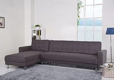 a living room with a gray couch and rug