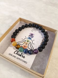 Beautiful genuine gemstones make up this Chakra & Lava Rock bracelet for a healthy, peaceful & balanced life. Add a drop of any essential oil to the lava rock beads to have your own personal diffuser bracelet & enjoy your relaxing aromas throughout the day! 7 Chakras and their beads: Root - Red Jasper Sacral - Yellow/Red Jade Solar Plexus - Tiger's Eye Heart - Green Aventurine Throat - Sodalite Third Eye - Lapis Lazuli Crown - Amethyst 7.5" Elastic Bracelet Candle Organization, Lava Rock Bracelet, Red Jade, Beaded Boxes, Balanced Life, Art Bag, Diffuser Bracelets, 7 Chakras, Lava Rock