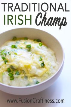 a white bowl filled with mashed potatoes and green onions, on top of a white table