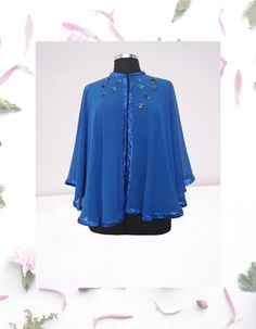 Feel like royalty in this stunning Royal blue chiffon evening cape/shawl.  This one-of-a-kind piece is hand embellished with artsy details, perfect for making a statement at any event. Each circle is meticulously hand embroidered with sequins and appliqued onto the cape with care.  The glitter ribbon frame trim adds an extra touch of elegance and sophistication to this beautiful evening cover up.  This L-XL cape is truly a work of art that will make you stand out in style. One of a kind  Fastene One Size Blue Cape, Blue One Size Cape, Blue One-size Cape, Party Chiffon Shawl, Half Cape, Dress Topper, Formal Top, Cape Shawl, Glitter Ribbon