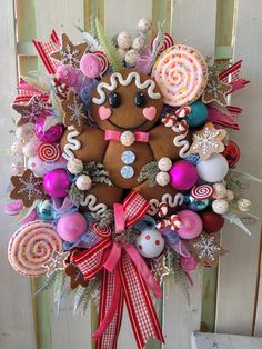 a gingerbread christmas wreath with candy, candies and lollipops on it