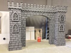 a model of a castle made out of legos and plastic bricks is shown in the process of being built