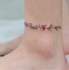 a small flower tattoo on the ankle