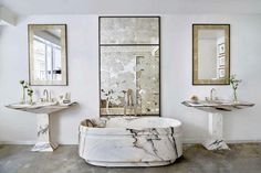 a bathroom with two sinks and a marble tub