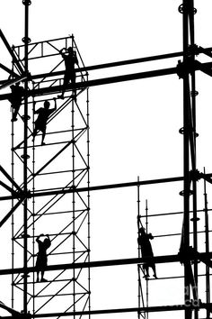 silhouettes of people working on scaffolding