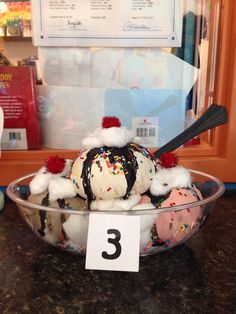 a bowl filled with ice cream and sprinkles on top of a table