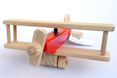 a wooden toy with a red object in it