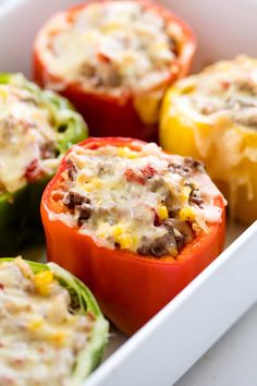 stuffed bell peppers in a white casserole dish