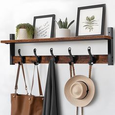 a wooden shelf holding two hats, purses and other items on it's hooks