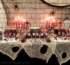 a decorated table with candles and skulls on it