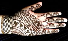 a hand with henna tattoos on it