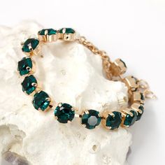 "Emerald GreenCrystal bracelet romantic yet elegant bracelet for any occasion. This bracelet made of Emerald Premium Quality Crystal (8 mm) bead and rose gold plated settings chain. Adjustable from 6 3/4\" to 9 1/4\". This bracelet measures about 6 3/4\" including trigger clasp, extender chain is 2 1/2\" long. This bracelet is packaging in an elegant organza pouch ready for gift giving. This bracelet is available in different finish: ...gold plated... ...rhodium plated... ...silver plated... You can choose your color during checkout. This bracelet you can wear with matching necklace or earrings (look last picture or links): Matching necklace: https://www.etsy.com/shop/martaky/items?search_query=emerald+necklace Matching earrings: https://www.etsy.com/ca/shop/martaky?ref=simple-shop-header- Green Crystal Bracelet For Wedding, Emrald Green Bracelet, Green Rhinestone Bracelets For Wedding, Emerald-cut Green Tennis Bracelet For Formal Occasions, Elegant Green Gold-plated Bracelet, Adjustable Jewelry, Emerald Necklace, Rose Gold Bracelet, Elegant Bracelet