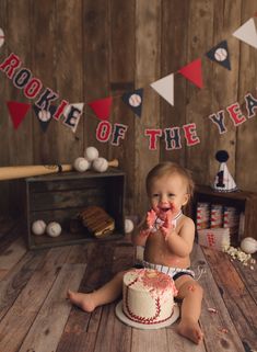 a baby is sitting in front of a cake