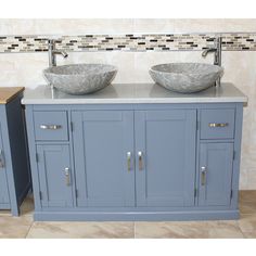 two sinks are shown in the middle of a bathroom with tile walls and flooring