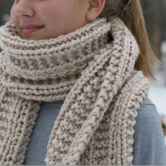 a woman wearing a knitted scarf in the snow